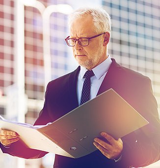 man looking at folder in his hands
